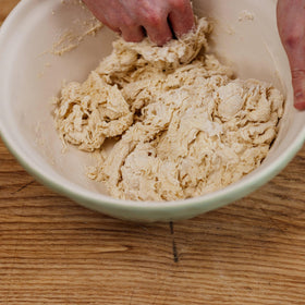 Gozney dough going into a home oven for high-heat baking
