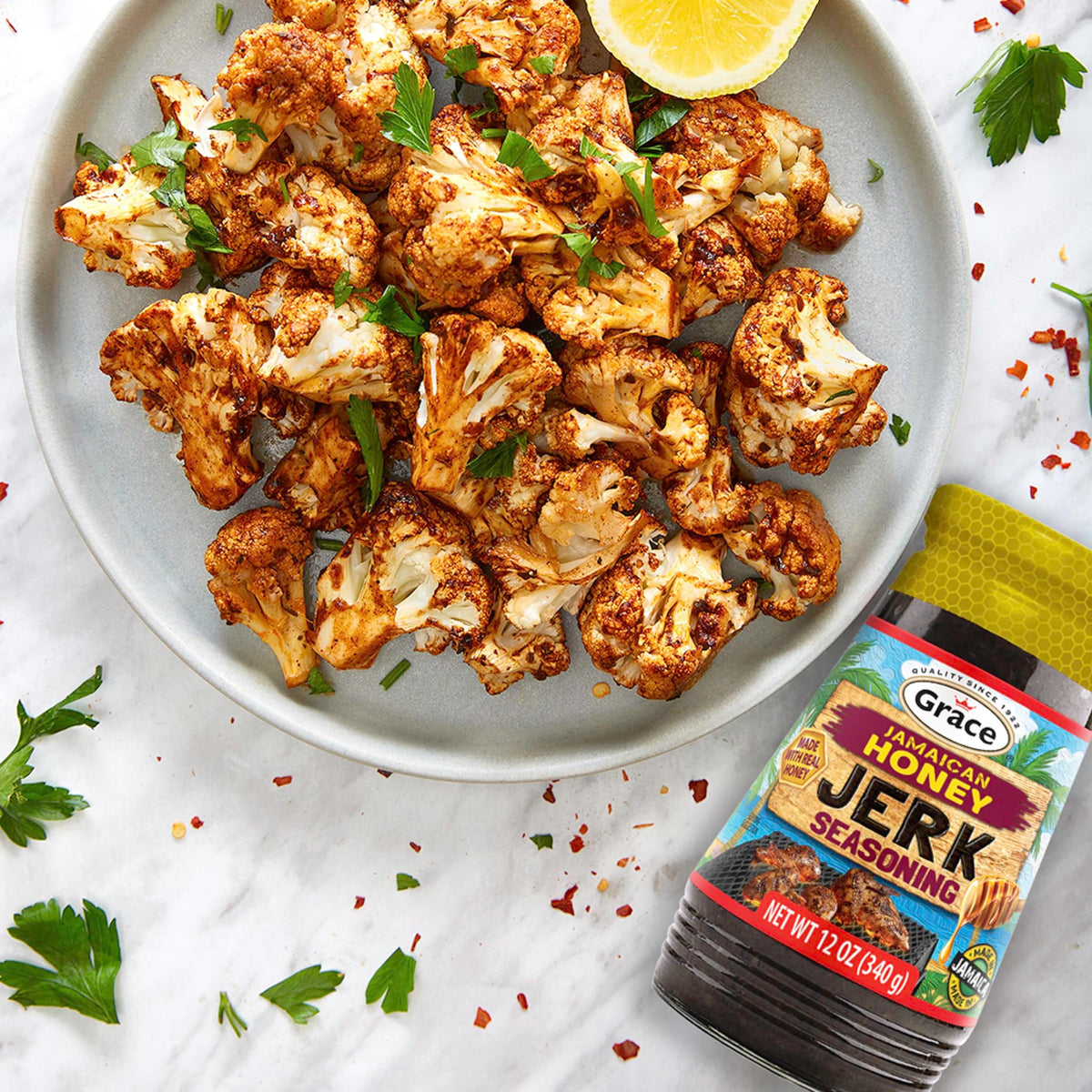 Grace Jamaican Honey Jerk Seasoning being poured for vibrant jerk flavor.