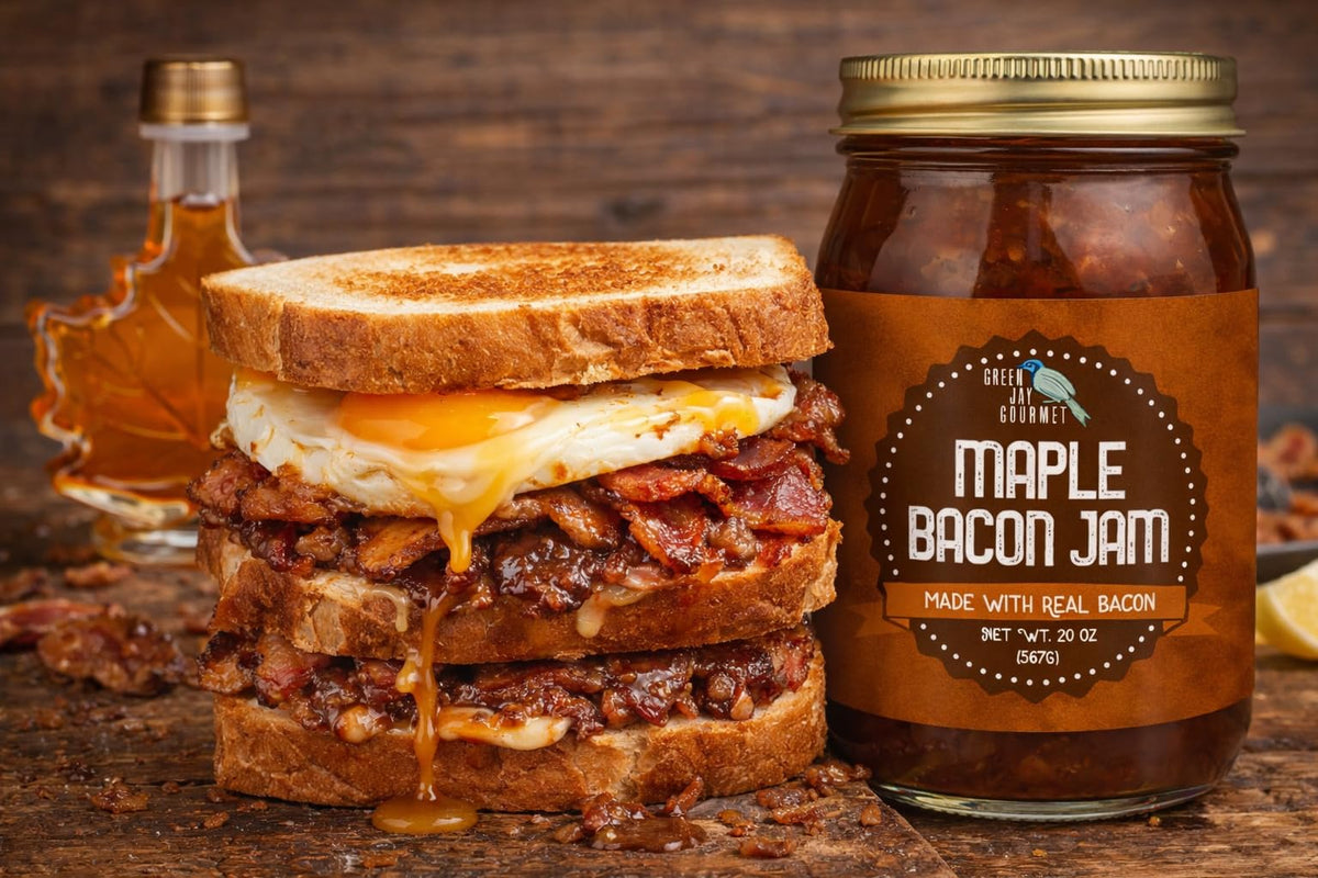 Green Jay Gourmet Maple Bacon Jam on a charcuterie board with cheeses