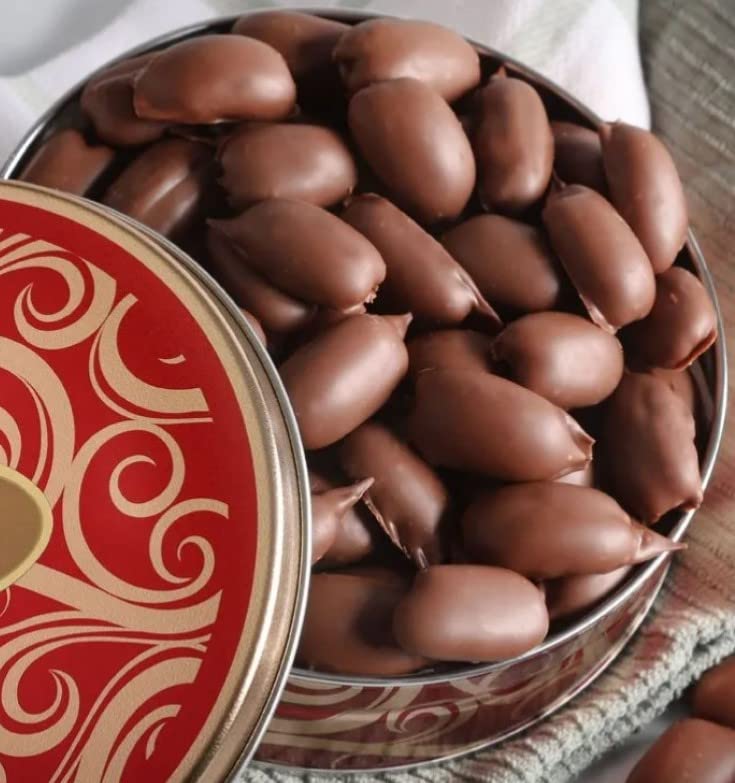 Greenoak fresh milk chocolate covered pecans in a gift tin, ideal for gifting.