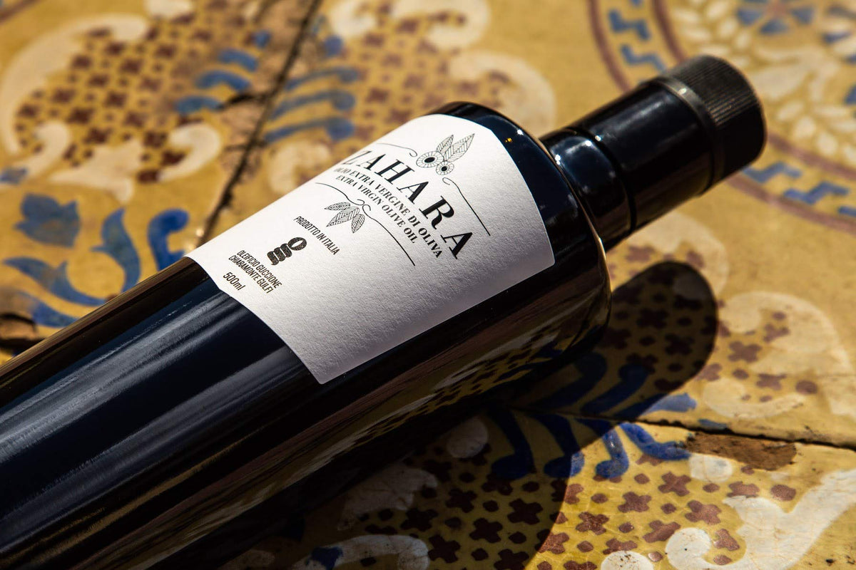 Oleificio Guccione Zahara EVOO kitchen scene conveys artisanal process and high-quality oil.