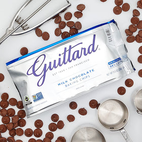 Close-up of Guittard Milk Chocolate Baking Chips cubes highlighting smooth texture.