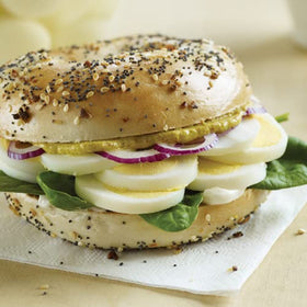 Gulden-s spicy brown mustard packets on a hot dog showcase bold flavor.