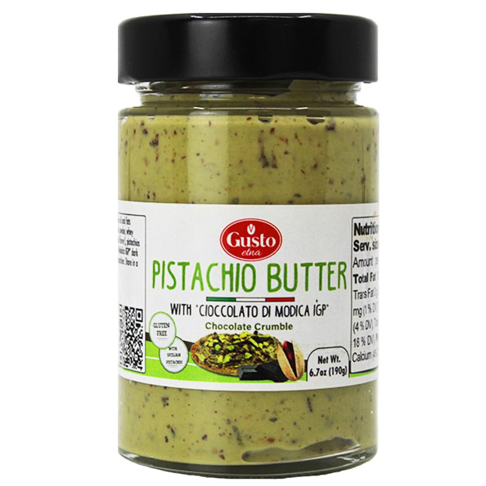GUSTO ETNA Pistachio Butter with Chocolate Chips jar on a kitchen counter, perfect for spreading on toast.