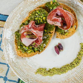 Gusto ETNA unsweetened pesto close-up highlighting vibrant pistachios.