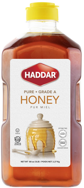 Haddar US Grade A bulk honey in amber bottle for drizzling over foods.