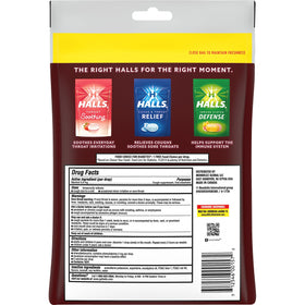 HALLS sugar-free black cherry drops dissolving on tongue for quick soothing