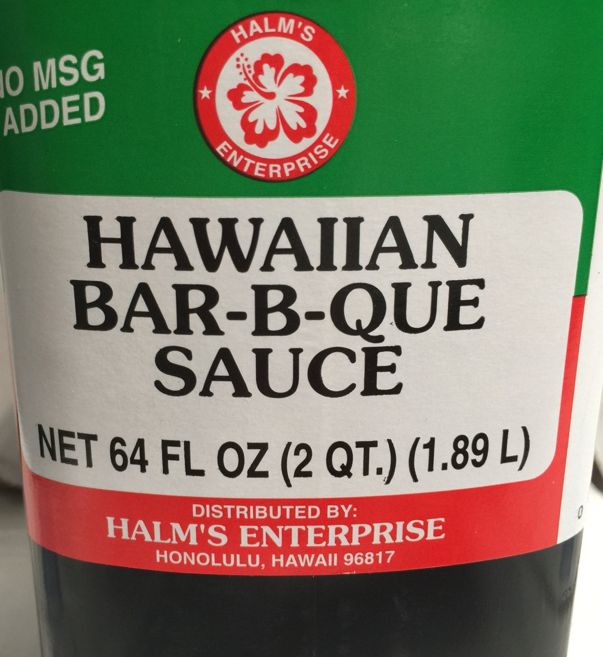 Halm's Hawaiian BBQ Bar-B-Que Sauce bottle pour showing glossy glaze for seafood.