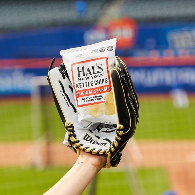 Hal's New York sea salt kettle chip in hand, ready for a quick office snack.