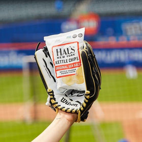 Hal's New York sea salt kettle chip in hand, ready for a quick office snack.
