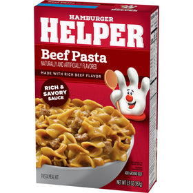 Hamburger Helper Beef Pasta ingredients spread with chopped onions nearby