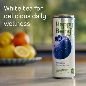 Happy Being Blueberry Sparkling White Tea ingredients laid out for natural wellness