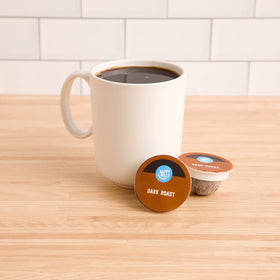 Happy Belly dark roast pods box back highlighting sustainability and compostable design.