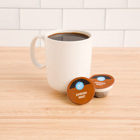 Happy Belly Espresso Roast pod closeup highlights rich aroma and dark roast.