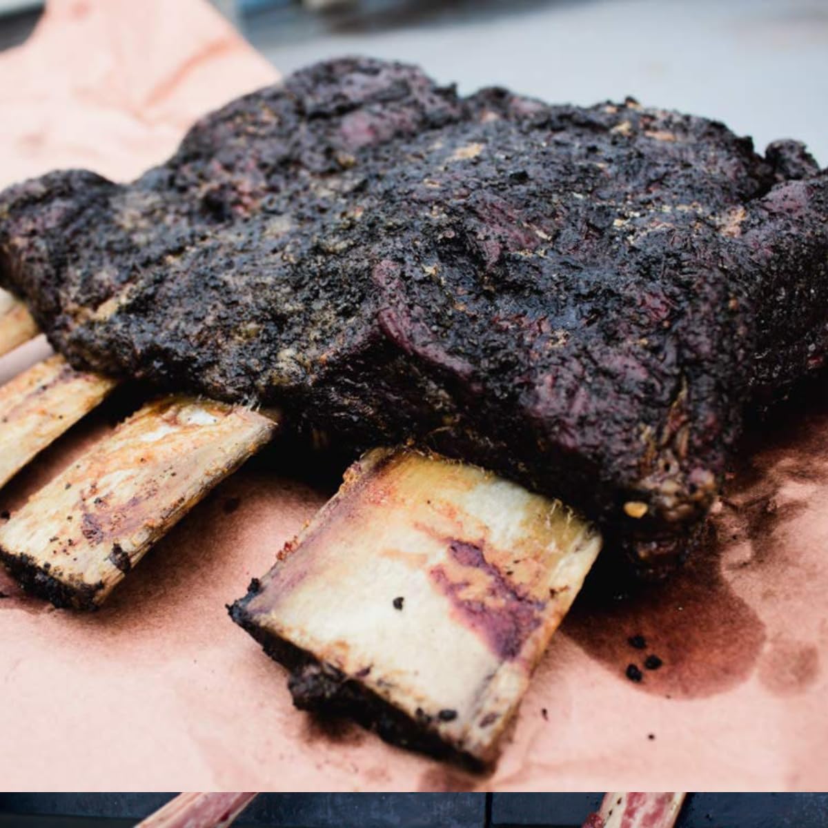 Hardcore Carnivore Black smoking barbecue scene — enhances flavor during outdoor cookouts.