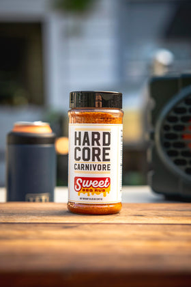 Hardcore Carnivore Sweet BBQ Seasoning label close-up, 12.25 oz shaker quality.