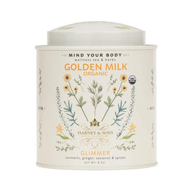 Harney & Sons Golden Milk Powder tin beside a mug, ideal for a soothing caffeine-free latte.