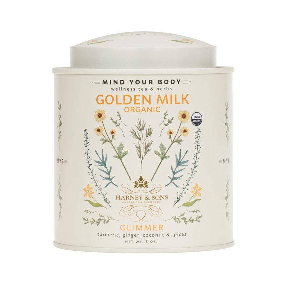 Harney & Sons Golden Milk Powder tin beside a mug, ideal for a soothing caffeine-free latte.