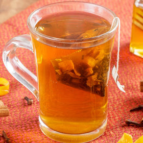 Close-up of Hot Cinnamon Spice tea sachet highlighting cinnamon, orange, and clove aromas.