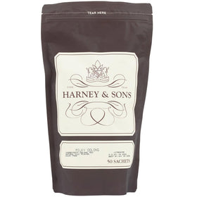 Harney & Sons Milky Oolong tea bag beside a cup with creamy aroma.