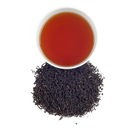 Harney and Sons Organic Assam tea leaves brewing in a cup with rich honey notes.