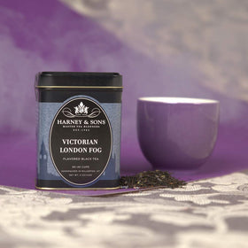 Harney and Sons Victorian London Fog tea tin on desk, inviting aroma for cozy teatime moments.
