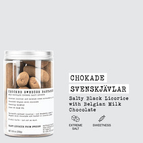 Close-up bite of Chokade Svenskvlar showing intense salmiak salt and chocolate layer.
