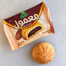 HB Halwani Bros Maamoul cookies beside a hot cup of tea, inviting pairing.
