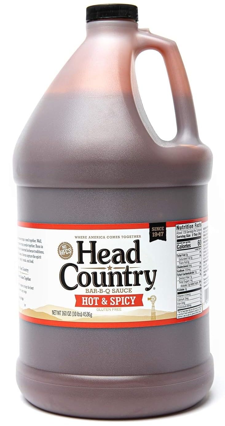 Head Country Hot & Spicy BBQ Sauce bottle pour, ideal for glazing grilled pork and chicken.
