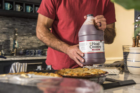 Head Country Original glaze on smoked meats for bold flavor.