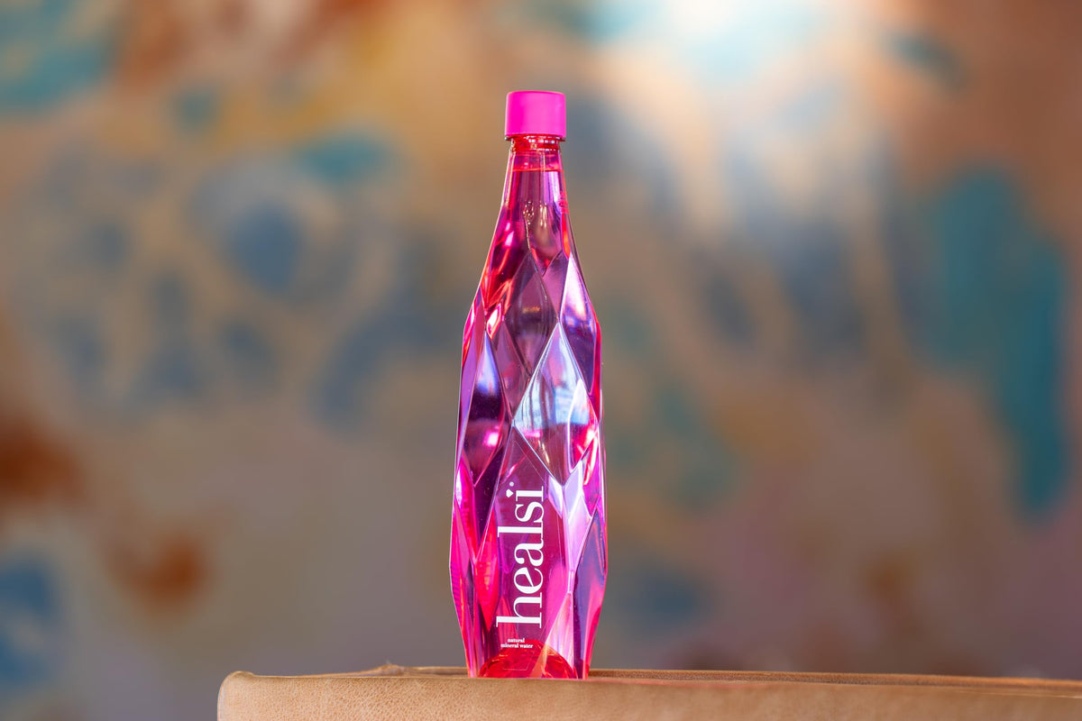 Healsi artesian water bottle in hand for portable daily hydration