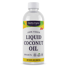 Healthy Origins Coconut Oil bottle on kitchen counter, ready for cooking.