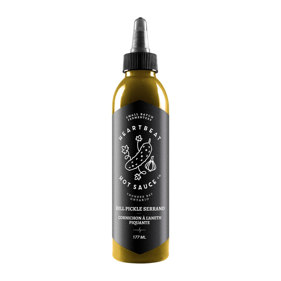Heartbeat Dill Pickle Serrano bottle ready to drizzle on eggs for tangy flavor