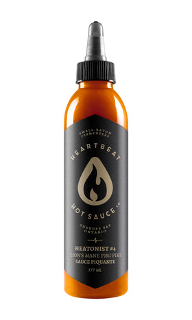 Heartbeat Hot Sauce Co. Lion's Mane Piri Piri bottle pour with balanced heat.