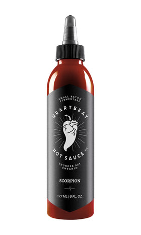 Heartbeat Hot Sauce Co. Scorpion bottle on kitchen counter for bold, versatile flavor.