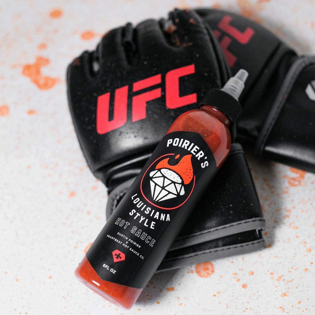Heartbeat Poirier Louisiana sauce glass highlights vibrant hues perfect for wings.