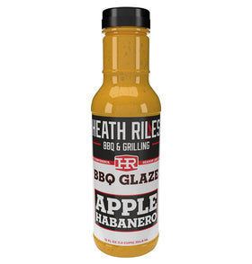 Hea th Riles BBQ Apple Habanero Glaze bottle being poured for rib glaze.