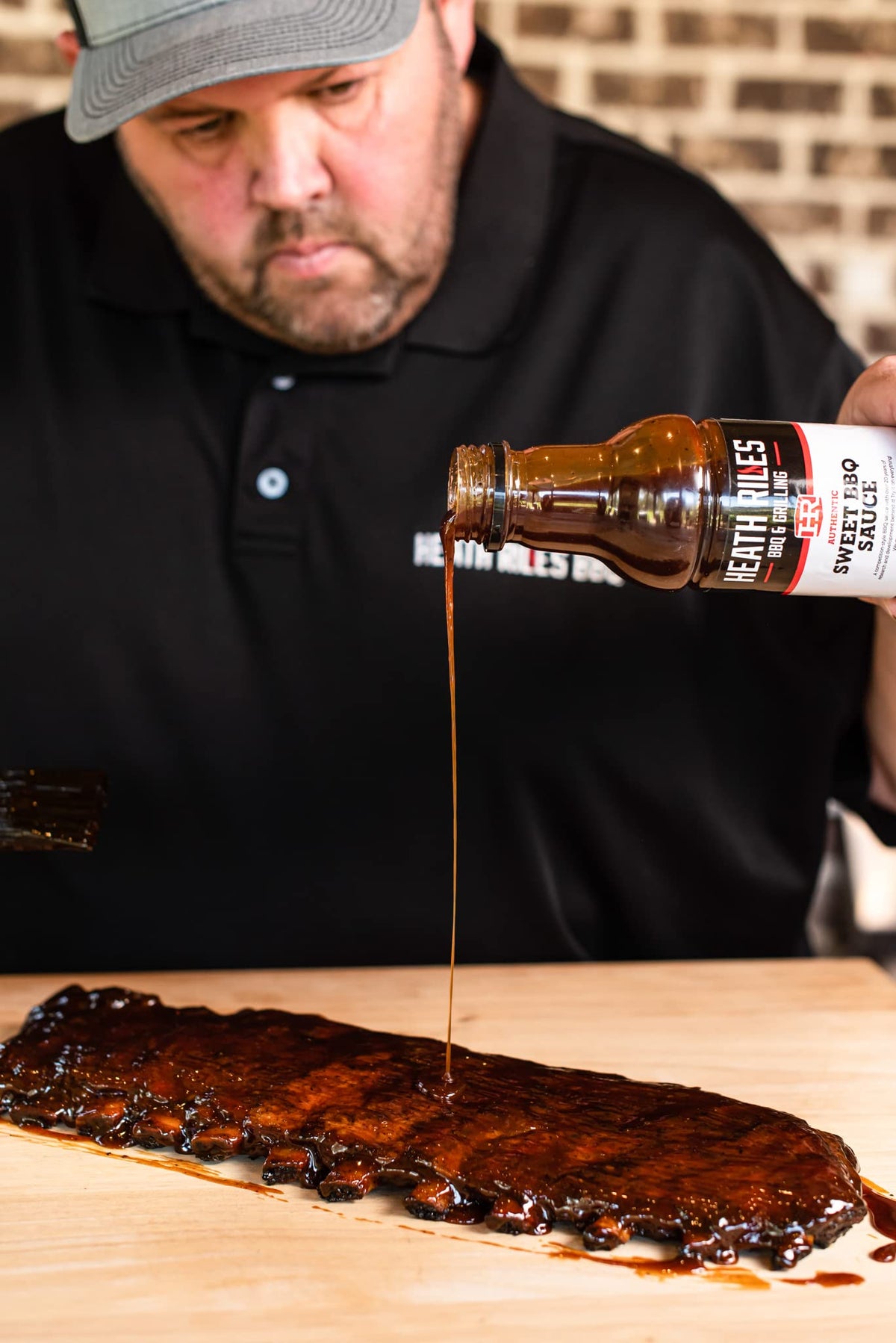 Heath Riles BBQ Sweet Barbecue Sauce chicken drumsticks adding flavor.