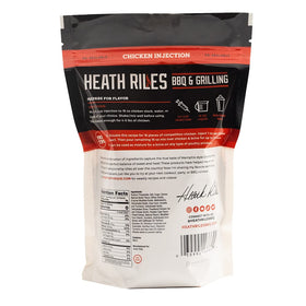 Heath Riles meat injector in use delivering moisture and spice to chicken.