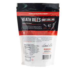 Heath Riles meat injector in use for evenly seasoned smoked pork