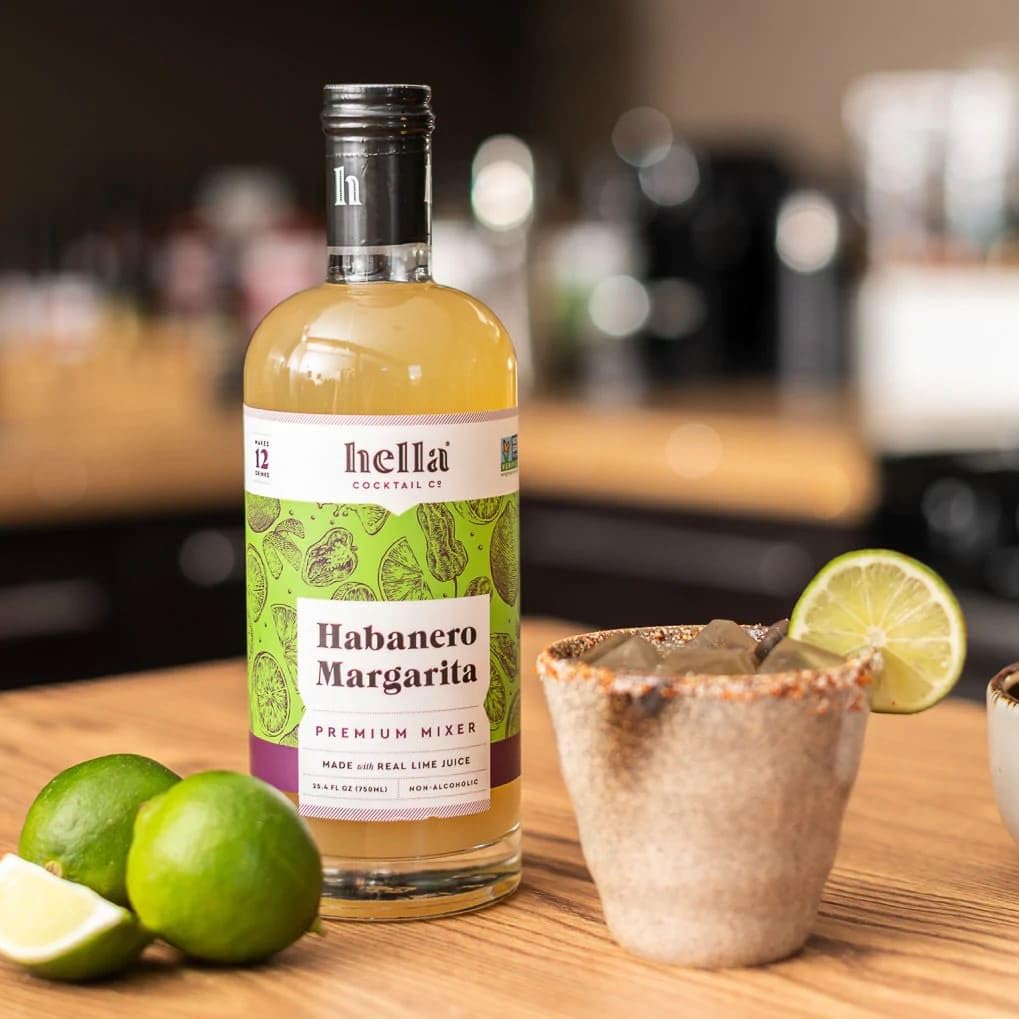 Hella Cocktail Co. Habanero Margarita Mixer being poured for bold, spicy cocktails.
