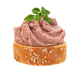 Pâté on a baguette slice ready for a French-inspired snack