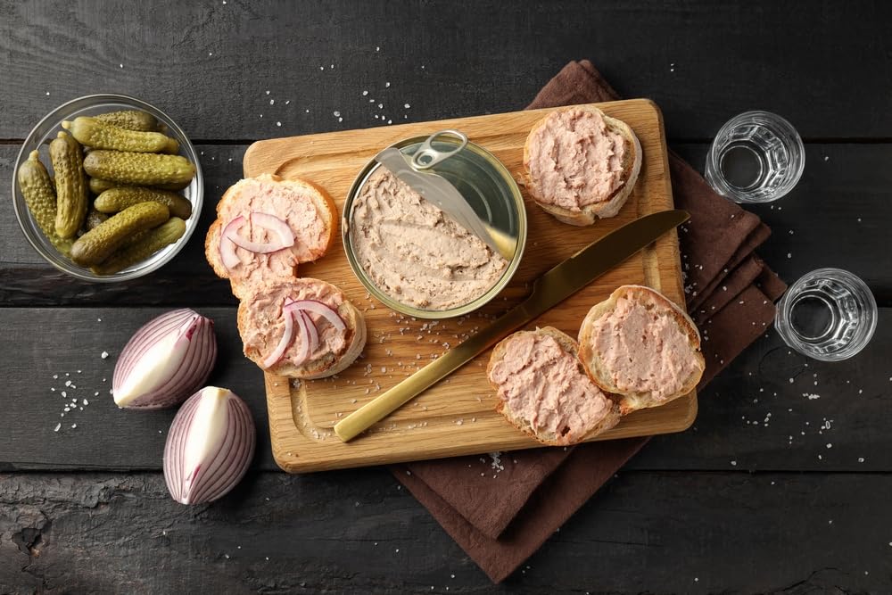 Hénaff pork liver pâté served with olives for a chic bite.
