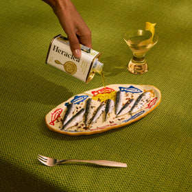 Heraclea Lemon Infused Olive Oil in kitchen with pour spout
