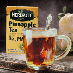 Herbacil Pineapple Tea cup with steam suggests hot, comforting infusion.