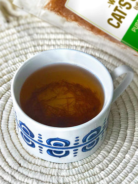 Brewing a pot of Cat's Claw Tea releasing earthy aroma