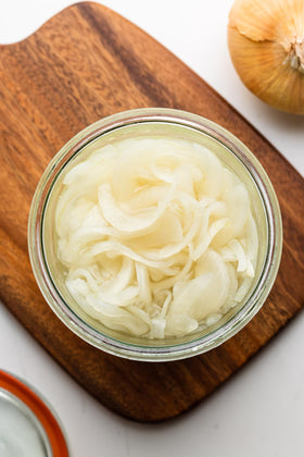 Herb's Pickled Sour Onions on a sandwich, adding bite and brightness.