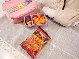 Herr's Hot & Honey Cheese Curls on the kitchen counter for a quick snack