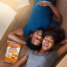 Herr's horseradish cheddar chips family snack spread captures shared flavor moments.