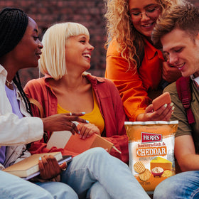 Herr's horseradish cheddar chips in lunchbox scene emphasizes convenient school lunch idea.